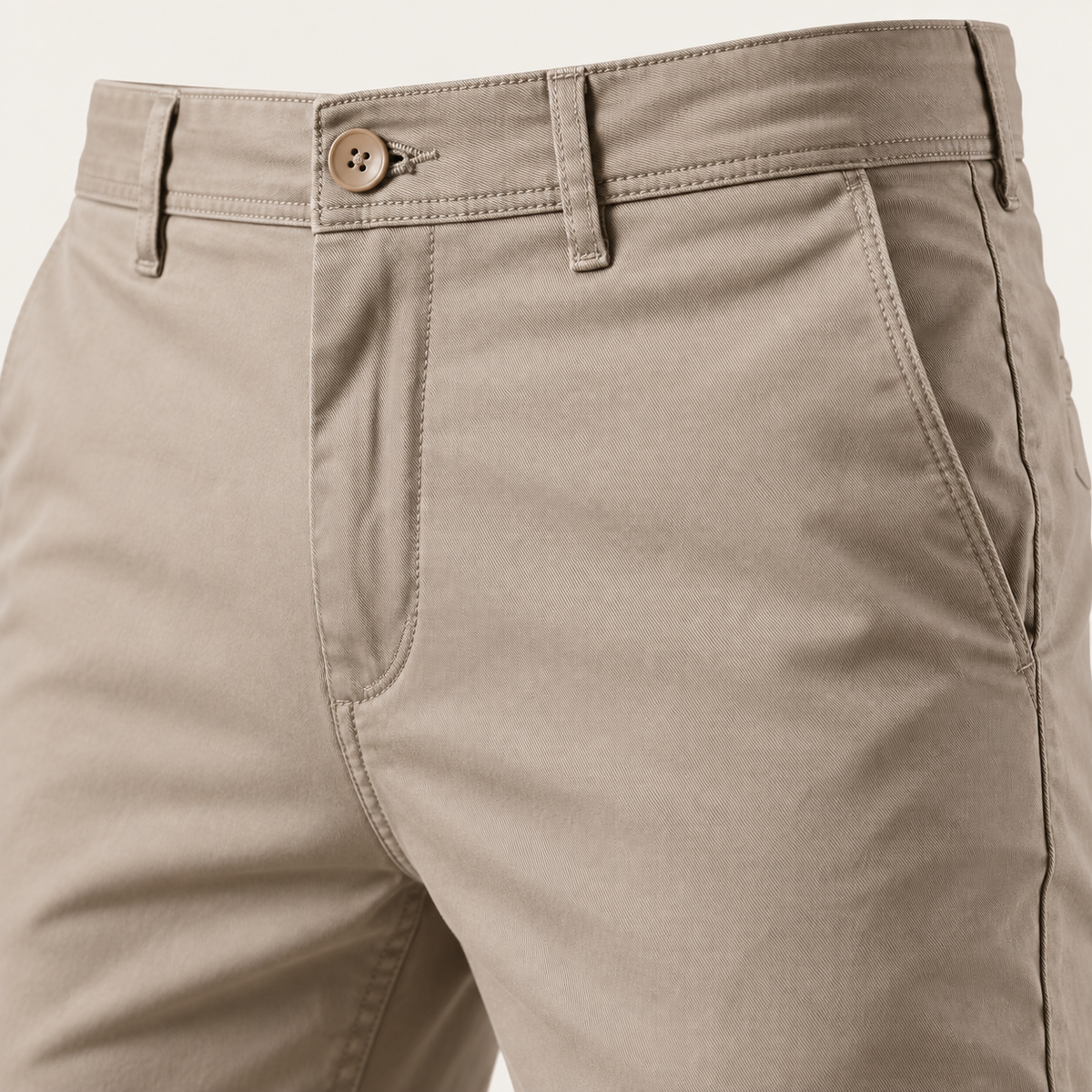 Close view of the waistband, button and pocket on the khaki chino