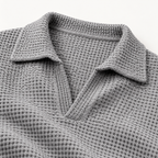 Close view of the notch collar and waffle texture on the grey polo