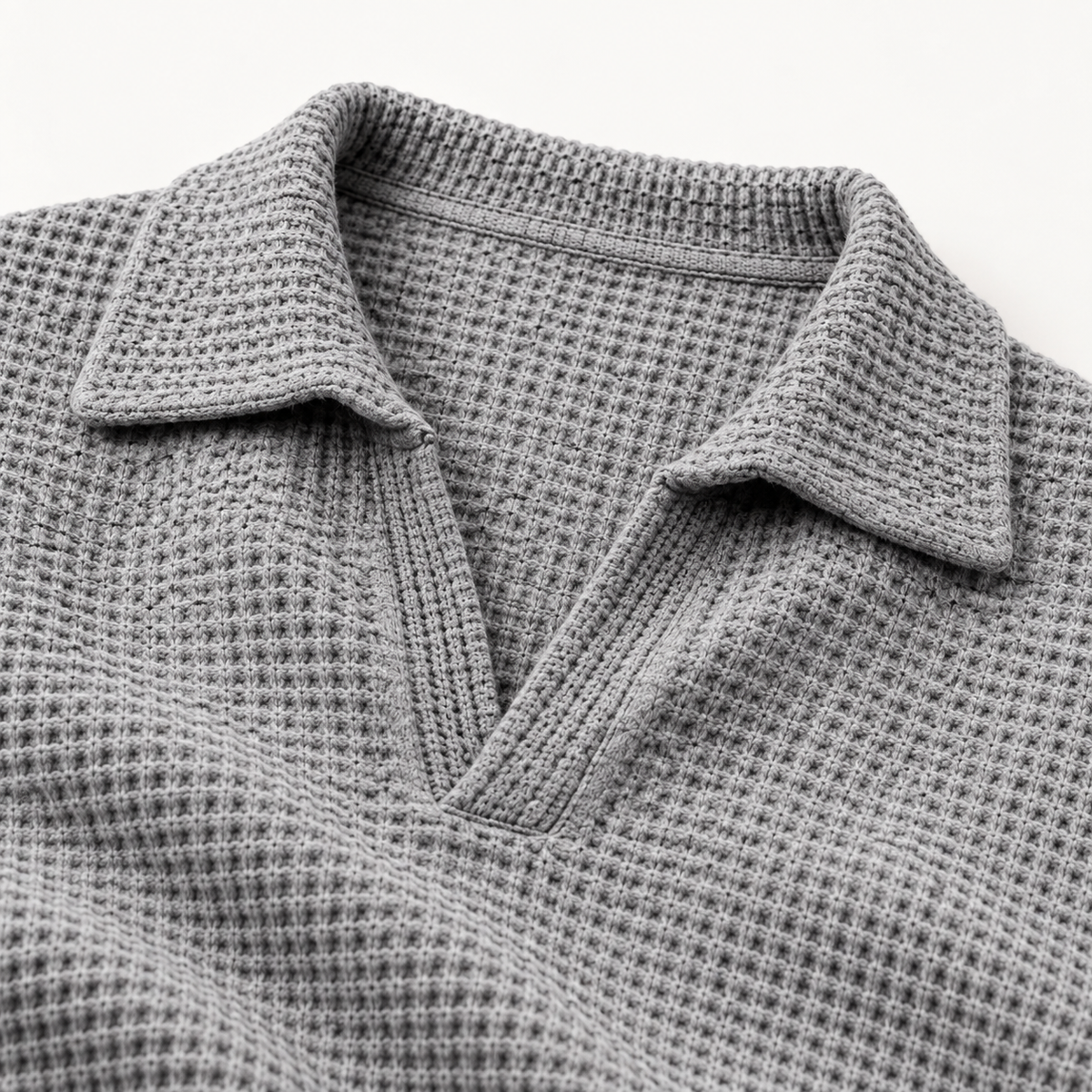 Close view of the notch collar and waffle texture on the grey polo